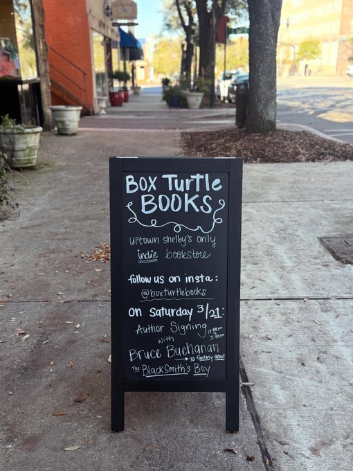 Box Turtle Books' chalkboard sign promoting Bruce Buchanan's recent book signing event